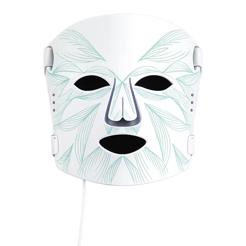 Roselle Wellness LED light therapy mask in white silicone with teal leaf patterns for at-home facial skincare